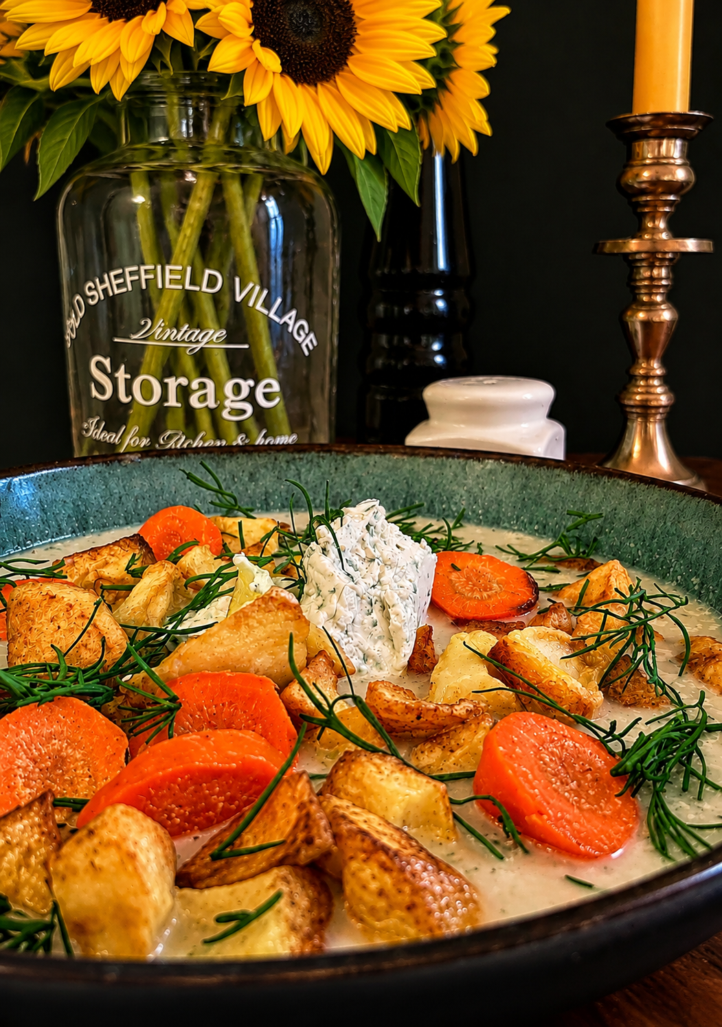 Lithuanian Turnip Soup, Ropių Sriuba, served in a rustic green ceramic bowl with golden roasted turnip and potato pieces, carrot slices, creamy vegetable broth, fresh dill and a generous spoonful of vegan sour cream.