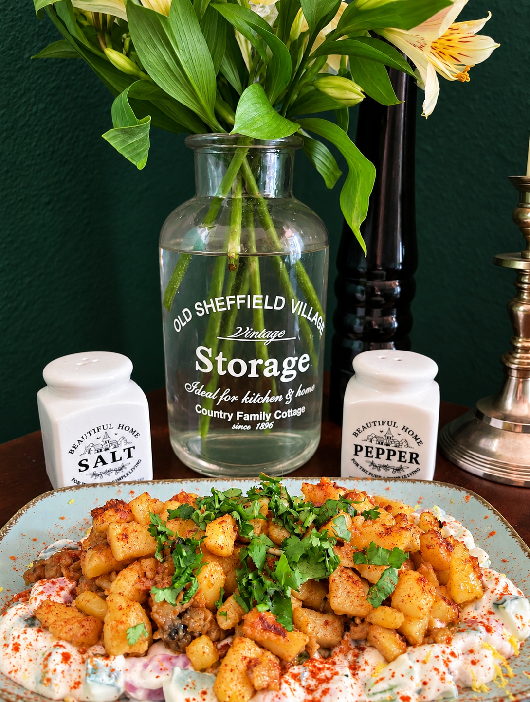 Vegan Algerian Batata Mchermla with golden crispy potatoes coated in spicy garlic chermoula, served on creamy soy yogurt with cucumber, tomato, lemon zest and fresh coriander.